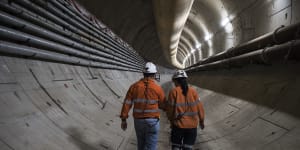 Abdalah El Sayed and engineer Jaime Cheuk walk down the Sydney metro tunnel. 