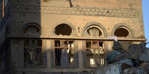 A boy looks from the window of his damaged house at the site of a Saudi-led airstrike near Yemen's Defence Ministry complex in Sanaa last Saturday.