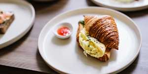 Scrambled egg croissant with house-made dukkah,herbs and chilli jam.