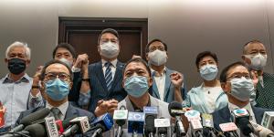 Pro-democracy lawmakers join hands during a press conference at the Legislative Council building on Wednesday..