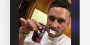 Valentine Holmes with a white bag in his mouth.