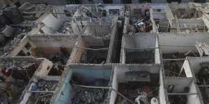 Palestinians look at the destruction after an Israeli strike on residential building in Rafah,Gaza Strip,on Tuesday.