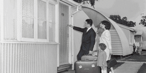 In a picture acquired Friday,27 May 2022 shows a nissen hut under development in an undated image. Pic - SUPPLIED Nissen Hut,Belmont. 24th May 2022 Photo Louise Kennerley SMH A migrant family enters their new home with hopeful faces at Maribyrnong,Victoria,1965. Nissen huts were a common feature of life in a ‘silver city’. Rosemary Roberts outside the newly renovated Nissen Hut where she grew up,4 Sommerset Street. Belmont. 24th May 2022 Photo Louise Kennerley SMH