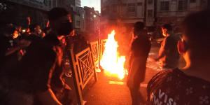 Protesters make a fire and block the street during a protest over the death of a woman who was detained by the morality police,in downtown Tehran,Iran.