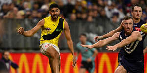 Marlion Pickett kicks the ball into play during Richmond’s clash against the Dockers in Perth on Saturday.