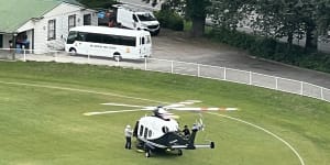 Lindsay Fox alighting from his helicopter on Melbourne High School’s oval.