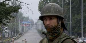 An Indian soldier guards a deserted road during lockdown in Srinagar,Indian controlled Kashmir,on Thursday.