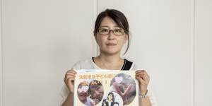 Izumi Dobashi with a photo of her three children. 