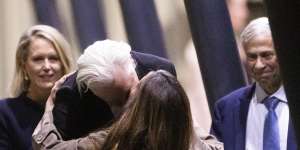 Julian Assange kisses his wife Stella Assange as lawyers Jennifer Robinson and Barry Pollack look on.