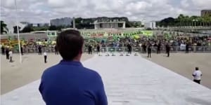 Brazil's president and supporters protest lockdown as coronavirus toll climbs
