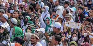 Supporters of Indonesian presidential candidate Anies Baswedan gather during a campaign event.