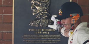 David Warner touches a tribute to Phillip Hughes at the SCG in 2015.