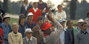 Lee Elder hits a drive during the practice round at the Masters in 1975.