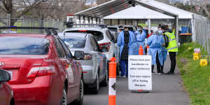 People queue in their cars at the Albert Park COVID-19 testing clinic on Friday.