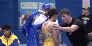 Outrage:High school wrestler Andrew Johnson gets his hair cut courtside minutes before his match in New Jersey.