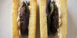 Crustless brioche finger sandwiches filled with dry-aged beef,soy sauce mayonnaise and pickled cucumber.