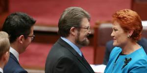 Senator Pauline Hanson is congratulated by Senator Derryn Hinch after delivering her first speech in the Senate,2016.