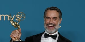 Bartlett celebrates after winning the Emmy for outstanding supporting actor in a limited anthology series or movie for The White Lotus.