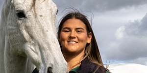 Molly Stewart and Chautauqua pose for a picture under the neck of Fawkner.
