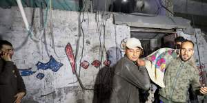 Palestinians are evacuated from a building hit by Israeli air strikes on in Rafah,Gaza.