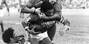 Kevin Stevens and a teammate tackle Newtown’s Ray Blacklock.