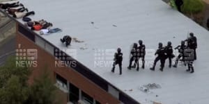 Officers storming the Banksia Hill Detention Centre rooftop on Wednesday.