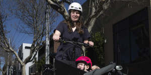 Mali Lewis with seven-month-old daughter Bea riding on a dedicated bike lane on Abbotsford Street,North Melbourne.