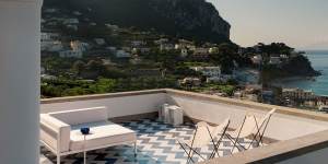 The terrace enjoys spectacular views of Capri’s lively port. Sofas by Kettal. Ceramic floor tiles from Villa Valguarnera and created by Galleria Elena Superfici.