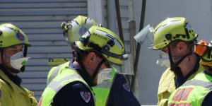 Cars covered by rubble after building collapse in Sydney's inner west