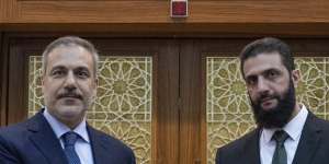 Turkish Foreign Minister Hakan Fidan,left,shakes hands with Ahmad al-Sharaa,formerly known as Abu Mohammed al-Jolani during their meeting in Damascus,Syria,on Sunday.