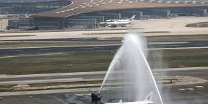 The plane is welcomed by water cannons at Beijing Capital International Airport.