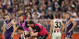 Lachie Schultz of the Magpies leaves the field injured during their round 9 match against the Fremantle Dockers.