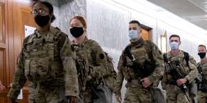 Members of the National Guard walk through Dirksen Senate Office Building in Washington,DC 