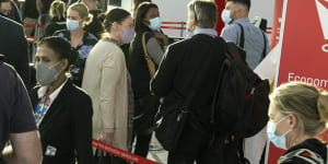 Qantas disruption-weary passengers queue at the domestic check in terminal at Sydney airport.