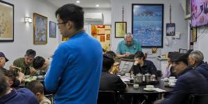 Anthony Kwok (standing,at rear) taking orders.