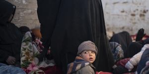 Women and children sit in the back of a truck as they wait to be screened by US-backed Syrian Democratic Forces after being evacuated out of the last territory held by Islamic State militants last month.