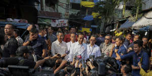 Jokowi,as he is widely known,fronts a local media pack during a visit to Pal Merah traditional market in Jakarta,Indonesia.