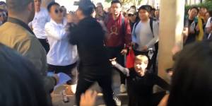 The first punch was thrown when the protest organiser approached two students after one of them stole his megaphone and threw it.