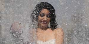 A member of an Australian cabaret and circus troupe cools down in a fountain on the Southbank in London as a heatwave sweeps across Britain.