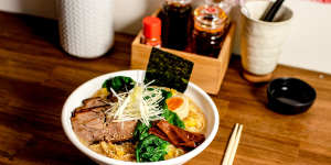 The menu's eight bowls of ramen are dominated by tori paitan broths,a rich chicken base,pictured here topped with charred pork belly.