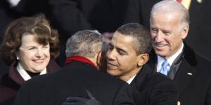 Dianne Feinstein and Joe Biden watch on during former president Barack Obama’s inauguration as he embraces civil rights leader Reverend Joseph E. Lowery 