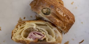 A ham and cheese croissant is a fat pillow of pastry loaded with gooey cheese and a lolling fold of cured pink meat.