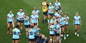 The NSW Waratahs console each other after their loss to the Fijiana in the Super W final.