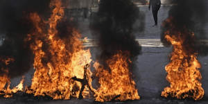 Palestinian demonstrators burn tires in a protest against a deadly Israeli army raid at Aida Refugee camp.