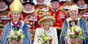 Queen Camilla holds a traditional Nosegay bouquet as she poses with Yeomen of the Guard and and religious representatives during The Royal Maundy Service at Worcester Cathedral on March 28.