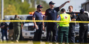 Law enforcement officials at the scene of a fatal shooting at the First Baptist Church in Sutherland Springs,Texas,on Sunday.