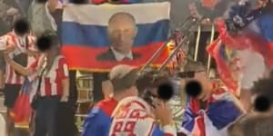 Screenshot of Russian fans carrying the national flag at Melbourne Park. Faces have been blacked out.