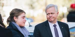ANU vice-chancellor Brian Schmidt comforts a student during a protest held outside the university's chancellory in response to the report into sexual harassment and assault at universities.