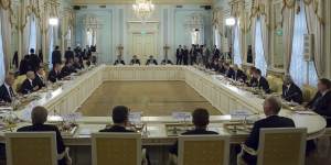 Russian President Vladimir Putin,fifth right,and Turkish President Recep Tayyip Erdogan,fifth left,attend a meeting with Turkish and Russian businessmen in the Konstantin palace.