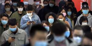 Commuters wear face masks to protect against the spread of new coronavirus as they walk through a subway station in Beijing,Thursday,April 9,2020. China's National Health Commission on Thursday reported dozens of new COVID-19 cases,including most of which it says are imported infections in recent arrivals from abroad and two"native"cases in the southern province of Guangdong. (AP Photo/Mark Schiefelbein)